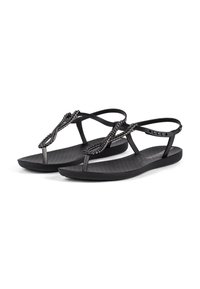 Black sandals with braided strap design, featuring a textured footbed and thin ankle straps. Flat sole with decorative accent details.
