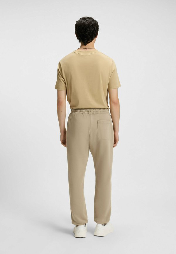 DUSPLITAN - Tracksuit bottoms - beige nine4