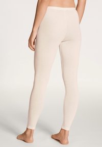 Hellbeige Leggings aus weichem, elastischem Stoff. Enganliegendes Design mit einem glatten Bund und Nahtdetails an der Rückseite und den Beinen.