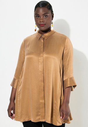 Blusa satinata color marrone chiaro con colletto, maniche a tre quarti e vestibilità morbida. Presenta una trama a righe sottili e una chiusura con bottoni.