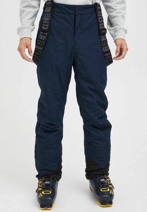 Navy blue snow pants with adjustable black suspenders, featuring a smooth texture, slightly loose fit, and reinforced lower panels.