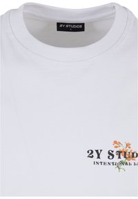 Tricou alb din bumbac cu guler rotund texturat, logo-ul imprimat "2Y STUDIOS" în negru și un design floral în portocalie și verde.