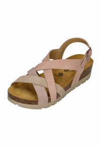 Pink and beige suede sandals with crisscross straps, a cushioned cork footbed, and a low, textured rubber sole. Adjustable ankle strap.
