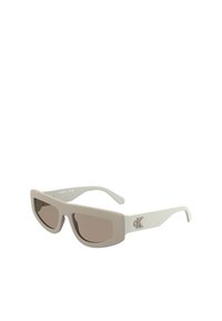 Sunglasses with a matte cream frame and brown tinted lenses. Features a rectangular design and a logo accent on the temple.