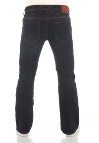 Jean en denim foncé à coupe droite, avec cinq poches et des coutures contrastantes. Dispose d'une étiquette en cuir marron à la taille.