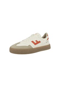 Sneaker with a cream leather upper, beige suede toe cap, and rubber sole. Features a vivid red logo and accents on the side.