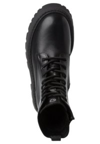 Bottes noires en cuir à la cheville avec une semelle épaisse, bout rond et de grosses lacets noirs. Dotées d'une languette à l'arrière pour un enfilage facile.