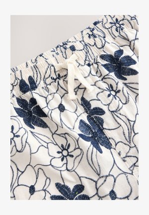 Lillepitsiline tikandiga lühikesed püksid kreemjas ja mereväesinis. Elastsest vöökohast reguleeritava nööriga. Omaduseks keerukad lillemustrit ja tekstuur.