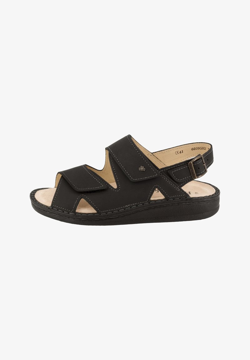 Sandale noire à bout ouvert avec brides ajustables, semelle intérieure beige coussinée et fermeture à boucle au talon pour un maintien sécurisé.