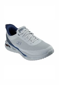 Zapatilla deportiva de malla gris con un collar acolchado en color azul marino, diseño con cordones y acentos azules. Presenta amortiguación y una etiqueta "Arch Fit" en el costado.