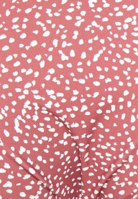 Tecido em um tom rosa antigo com um padrão abstrato salpicado em branco; textura suave com um acabamento liso, adequado para diversos designs.