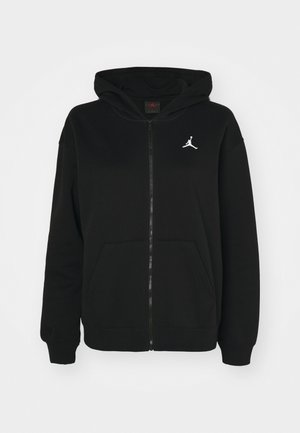 Zwarte rits hoodie van een katoenmix. Heeft een capuchon, voorzakken en een wit Jumpman-logo op de borst. Zachte textuur.
