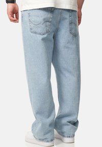 Light blue denim jeans feature a relaxed fit, with a classic five-pocket design and contrasting stitching on the back pockets.