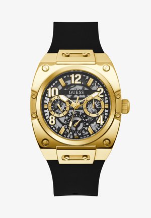 Goldfarbene Uhr mit einem schwarzen Gummiband. Verfügt über ein schwarzes, strukturiertes Zifferblatt mit goldenen Akzenten und mehreren Unterzifferblättern. Auffällige Stundenmarkierungen.