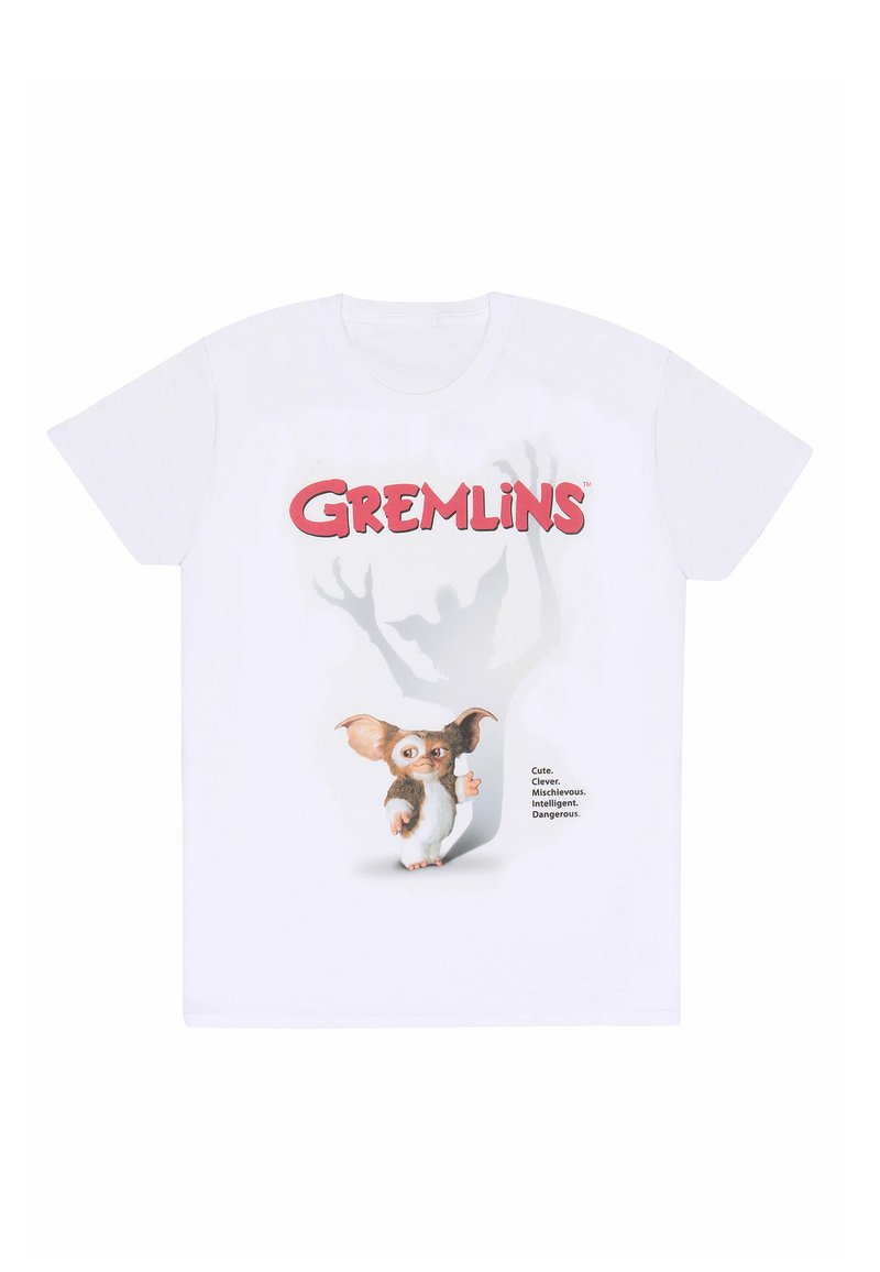Bílé bavlněné tričko s grafikou malého tvora s velkýma ušima a hravým výrazem, doplněné textem „Gremlins“ a popisy.