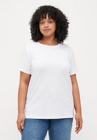 White cotton t-shirt with short sleeves and a round neckline, featuring a relaxed fit and smooth, even texture. No visible patterns or accents.