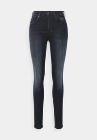 Jeans skinnys de cintura alta en denim azul oscuro. Presentan cinco bolsillos, un ligero desgaste y una textura suave y ligeramente elástica.
