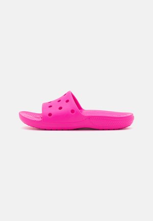 Pink rubber slide sandal with a wide strap featuring multiple ventilation holes, textured footbed, and a textured outsole for grip.