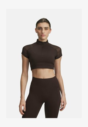 Brown cropped athletic top with short sleeves, high neckline, and zipper detail. Made from a smooth, stretchy fabric with slight sheen.