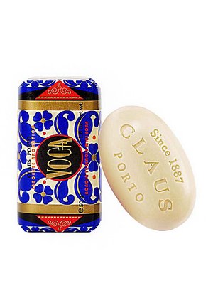 Blue and white floral-patterned soap wrapper beside a beige oval soap, embossed with "CLAUS" and "Since 1887," featuring smooth, creamy texture.