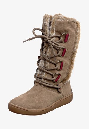 Botte d'hiver en suède brun avec bordure en fourrure, lacets à l'avant avec œillets métalliques, et semelle en caoutchouc plate pour un usage extérieur décontracté.