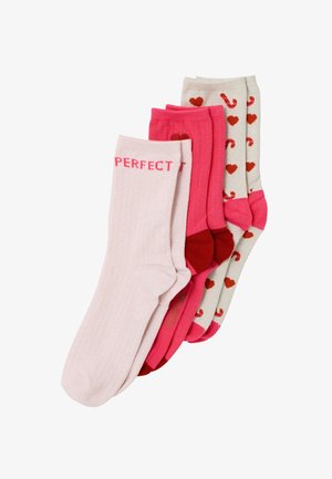 Quatre paires de chaussettes aux tons roses et beige. Deux paires unies roses, une avec le texte "PERFECT", une autre décorée de cannes en bonbon et de cœurs.