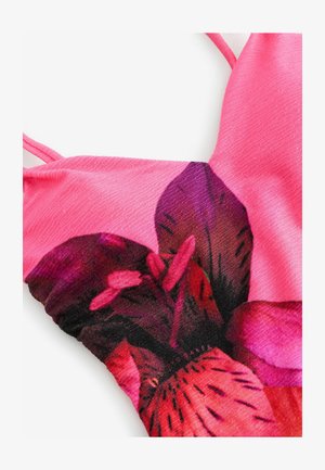 Rosa Stoffoberteil mit floralem Design und großen lila und roten Blumen. Strukturierte Oberfläche mit dünnen Trägern und figurbetonter Passform.