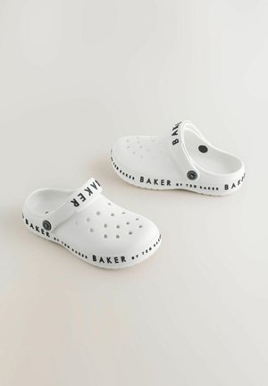 Valged klotsid perforatsiooniga, millel on rihmal must "BAKER" logo. Valmistatud siledast materjalist ja ümarate kujudega.