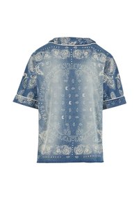 Denim short-sleeved shirt featuring a white paisley pattern, collar, and loose fit. Faded blue color with a mixture of light and dark shades.
