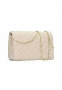 Quilted cream handbag with a rectangular shape, gold chain strap, and smooth texture. Features a clasp closure and minimalist design.