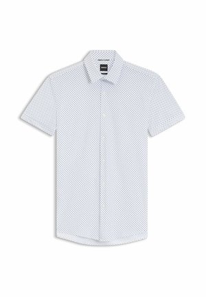 Camisa blanca de manga corta con botones, pequeños lunares negros y cuello, extendida sobre un fondo blanco.