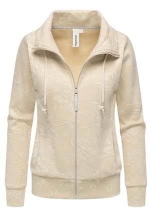 Sweat à capuche zippé beige avec un motif floral, fabriqué en tissu texturé. Dispose d'un col haut, de cordons de serrage et de poignets élastiques.