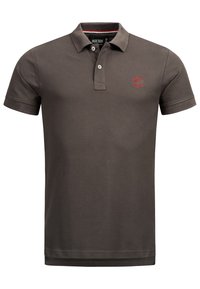 Polo shirt marron foncé en coton, avec un col, une patte de boutonnage à deux boutons et un logo rouge brodé sur la poitrine.