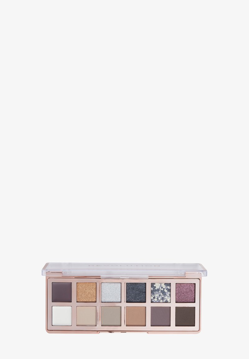 Øyeskyggepalett med 12 nyanser, inkludert matte og shimmers. Fargene varierer fra hvit, gull og beige til mørk lilla og svart. Klar lokk.