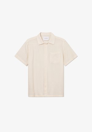 Short-sleeve cream shirt made of textured fabric, featuring a button-down front and a single chest pocket. Label on the collar reads "LES DEUX."