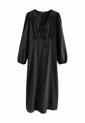 Robe noire avec un décolleté en V et un détail à nouer au centre. Elle présente de longues manches bouffantes et une coupe décontractée, fabriquée en tissu lisse.