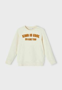 Cream-colored sweatshirt with raglan sleeves. Features "KIND IS COOL SO ARE YOU" in textured brown letters on the front. Soft fabric.