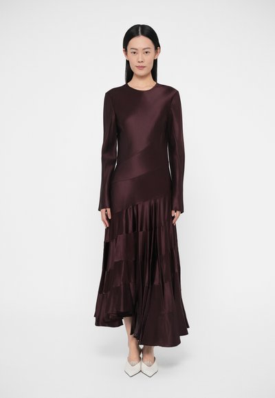 Wine-colored satin dress with a round neckline, long sleeves, and tiered ruffle hem. Smooth texture with a flowing silhouette.