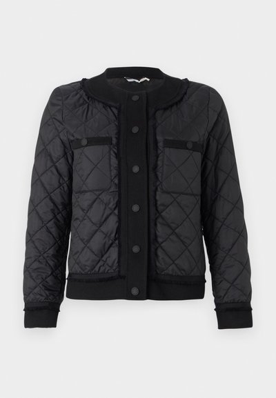 Black quilted jacket with a round collar, two front pockets, button closure, and ribbed cuffs and hem. Features a fringed trim along the edges.