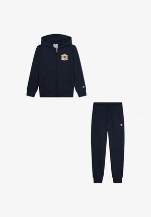 Dunkelblaue Kinderzipperjacke mit Pfannkuchen-Grafik und passenden Jogginghosen, beide mit kleinen Champion-Logos.