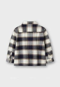 Plaid flannel shirt in navy, gray, and cream, featuring a collar, long sleeves, and buttoned cuffs, with a back yoke detail.