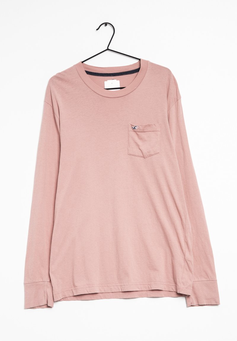 Long-sleeve shirt in dusty pink cotton with a chest pocket; features a crew neck and a tag on the shoulder. Soft, smooth texture.