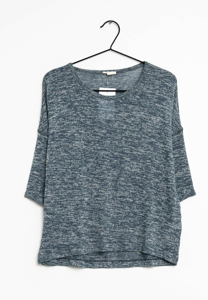 Short-sleeve top hanging on a black hook, made of textured navy fabric with a heathered pattern, featuring a wide neckline and relaxed fit.