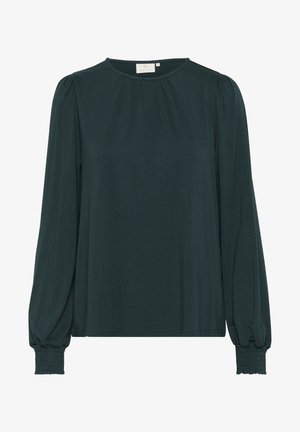 Tamsiai žalia ilgos rankovės bluzonė su apvaliu iškirpimu, raukšlėta priekyje ir susiraukšlėtais rankogaliais. Pagaminta iš lygaus, lengvo audinio.