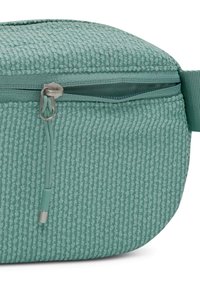 Light green textured fabric pouch with a partially open zipper and a green strap on the side.