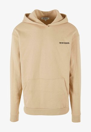 Bežinė gobtuvė, pagaminta iš švelnaus medvilninio audinio, su priekiu kišene, raštuotais rankogaliais ir mažuoju juodu logotipu ant krūtinės.