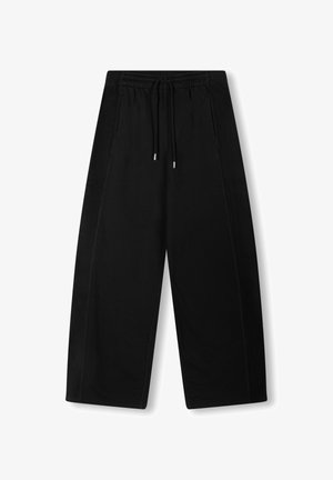 Black wide-leg pants made of soft fabric, featuring an elastic waistband with drawstring and two side pockets with contrasting side panels.