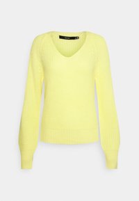 Stickad tröja i klar gult med V-hals, långa ärmar, ribbad textur och en figurnära nederkant. Har en enkel, strukturerad design.