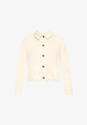 Cream long-sleeve jacket with collar, gold buttons down front, two chest pockets, and floral lace cutout detail at hem.