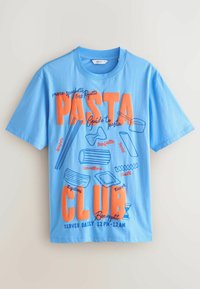 T-shirt en coton bleu clair avec un imprimé graphique portant les mots "PASTA CLUB" en orange et bleu, accompagné de diverses illustrations et détails de pâtes.